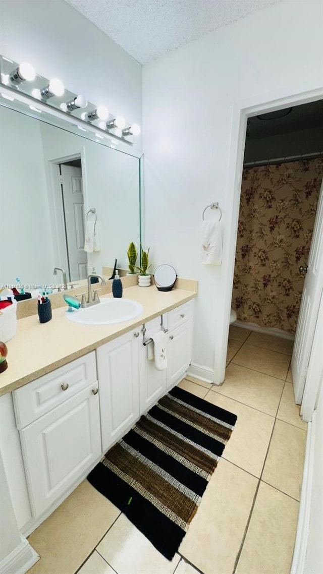 5122 NW 79th Ave Unit 301, Doral, FL 33166 - full bathroom featuring tile patterned flooring, vanity, a textured ceiling, baseboards, and toilet