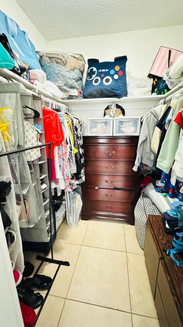 5122 NW 79th Ave Unit 301, Doral, FL 33166 - spacious closet featuring tile patterned floors