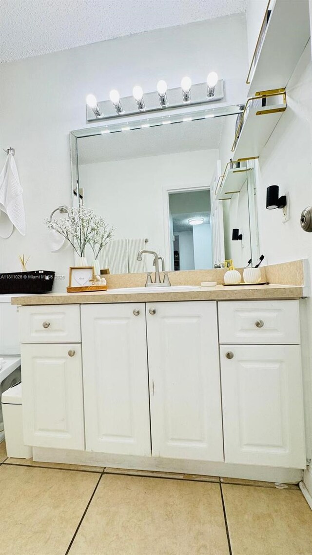 5122 NW 79th Ave Unit 301, Doral, FL 33166 - bathroom featuring tile patterned floors, vanity, and a textured ceiling