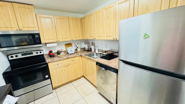5122 NW 79th Ave Unit 301, Doral, FL 33166 - kitchen featuring stainless steel appliances, light brown cabinets, a sink, light countertops, and light tile patterned flooring