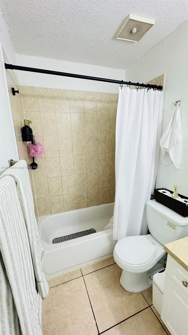 5122 NW 79th Ave Unit 301, Doral, FL 33166 - full bathroom with vanity, toilet, a textured ceiling, tile patterned floors, and shower / bath combination with curtain