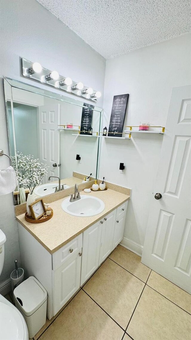 5122 NW 79th Ave Unit 301, Doral, FL 33166 - bathroom with toilet, tile patterned floors, vanity, and a textured ceiling