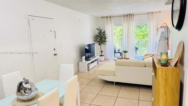 5122 NW 79th Ave Unit 301, Doral, FL 33166 - living room featuring light tile patterned floors and a textured ceiling
