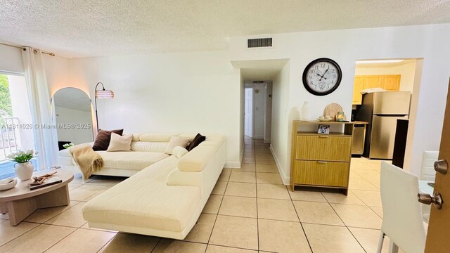 5122 NW 79th Ave Unit 301, Doral, FL 33166 - living area with a textured ceiling and light tile patterned flooring