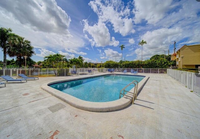 5122 NW 79th Ave Unit 301, Doral, FL 33166 - community pool with a patio area