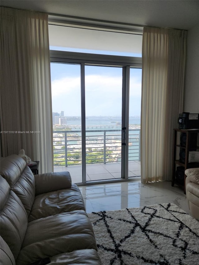 325 S Biscayne Blvd Unit 14, Miami, FL 33131 - living area featuring marble tiled flooring, a water view, and plenty of natural light