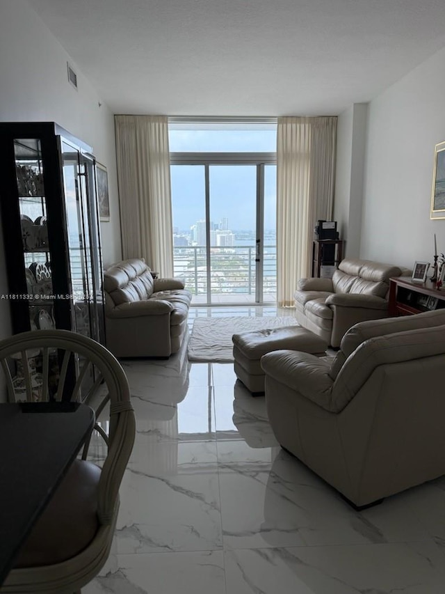 325 S Biscayne Blvd Unit 14, Miami, FL 33131 - living area featuring a wall of windows and marble finish floors