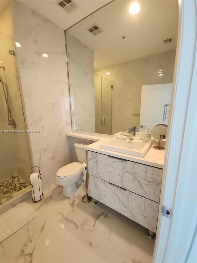 325 S Biscayne Blvd Unit 14, Miami, FL 33131 - full bathroom featuring marble tiled floors, a marble finish shower, vanity, and toilet
