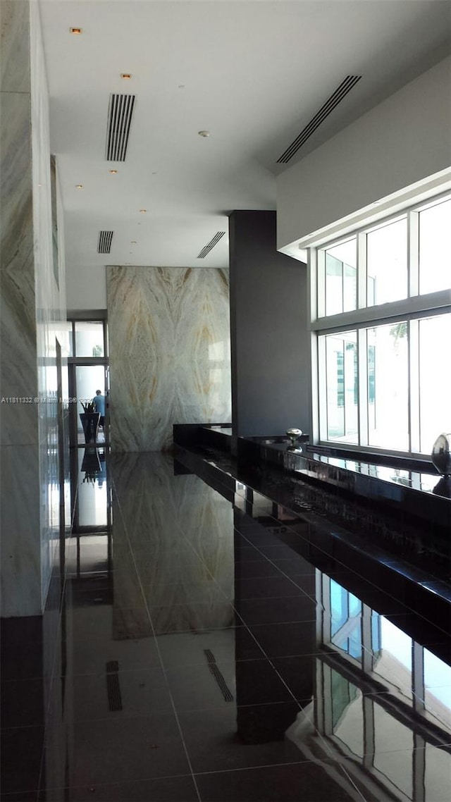 325 S Biscayne Blvd Unit 14, Miami, FL 33131 - hall with tile patterned flooring and tile walls