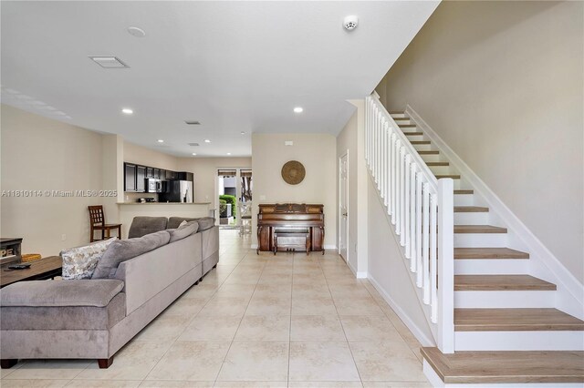 9471 SW 171st Pl, Miami, FL 33196 - living room with stairway, light tile patterned flooring, baseboards, and recessed lighting