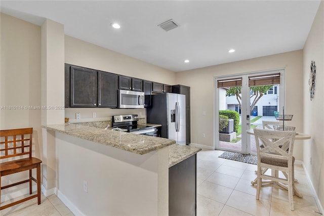 9471 SW 171st Pl, Miami, FL 33196 - kitchen with appliances with stainless steel finishes, baseboards, light stone countertops, light tile patterned floors, and recessed lighting