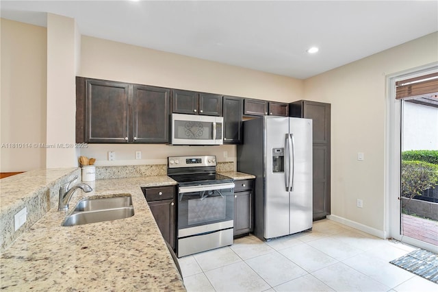9471 SW 171st Pl, Miami, FL 33196 - kitchen featuring appliances with stainless steel finishes, a sink, dark brown cabinets, light tile patterned floors, and recessed lighting