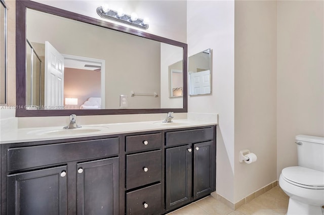 9471 SW 171st Pl, Miami, FL 33196 - full bathroom featuring tile patterned floors, toilet, double vanity, connected bathroom, and baseboards