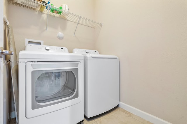 9471 SW 171st Pl, Miami, FL 33196 - laundry room featuring washing machine and clothes dryer, baseboards, and light tile patterned flooring