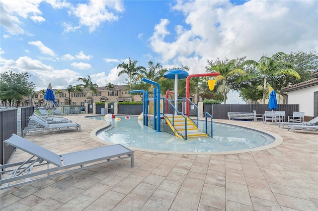 9471 SW 171st Pl, Miami, FL 33196 - view of swimming pool featuring a water play area and a patio