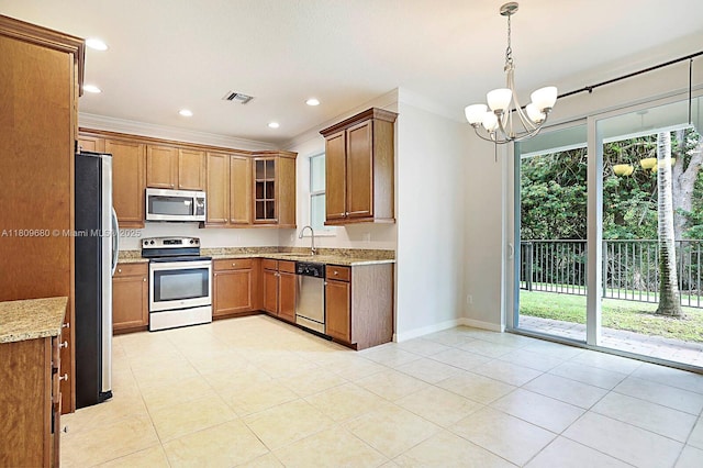 4631 Mediterranean Cir, Palm Beach Gardens, FL 33418 - kitchen with stainless steel appliances, a sink, a chandelier, light stone counters, and brown cabinets