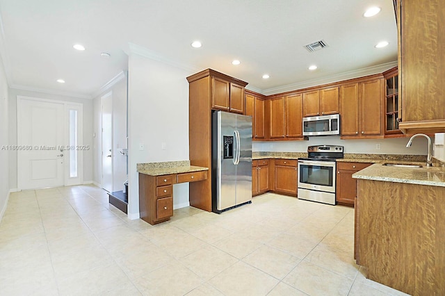 4631 Mediterranean Cir, Palm Beach Gardens, FL 33418 - kitchen with appliances with stainless steel finishes, ornamental molding, brown cabinetry, recessed lighting, and light stone countertops