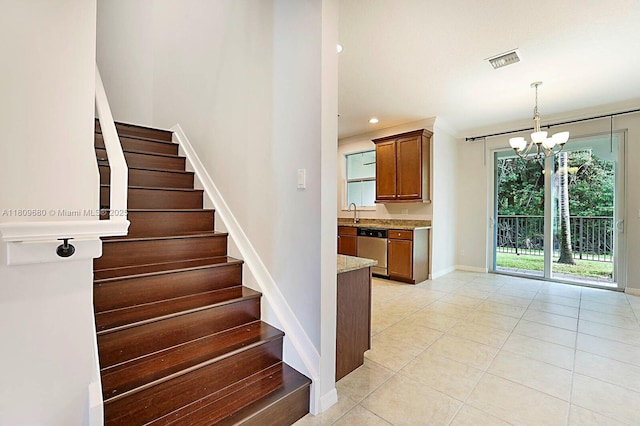 4631 Mediterranean Cir, Palm Beach Gardens, FL 33418 - stairs with tile patterned floors, a chandelier, and recessed lighting