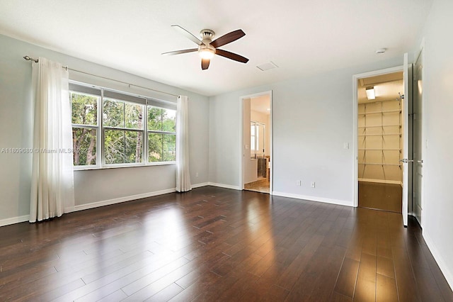4631 Mediterranean Cir, Palm Beach Gardens, FL 33418 - unfurnished bedroom featuring baseboards, dark wood-style flooring, ceiling fan, and ensuite bathroom