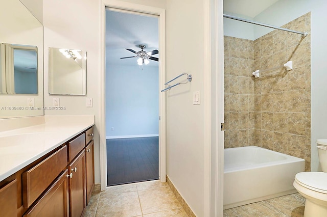 4631 Mediterranean Cir, Palm Beach Gardens, FL 33418 - bathroom with toilet, vanity, baseboards, bathtub / shower combination, and ceiling fan