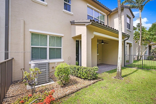 4631 Mediterranean Cir, Palm Beach Gardens, FL 33418 - rear view of house featuring stucco siding, central air condition unit, a ceiling fan, and a patio area