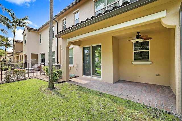 4631 Mediterranean Cir, Palm Beach Gardens, FL 33418 - rear view of property featuring stucco siding, a ceiling fan, a patio, and a tiled roof