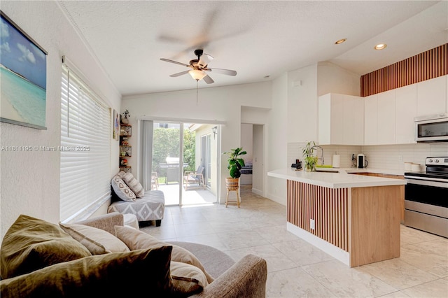 1482 Canary Island Dr, Weston, FL 33327 - kitchen with electric range, vaulted ceiling, open floor plan, light countertops, and ceiling fan