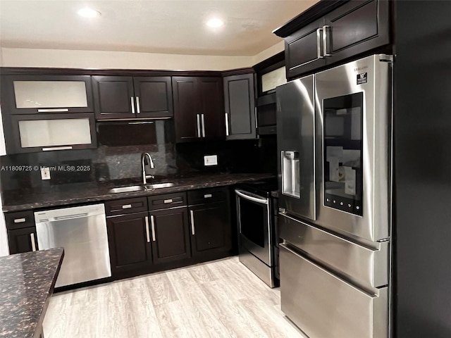 4888 NW 8th Ct, Plantation, FL 33317 - kitchen with appliances with stainless steel finishes, a sink, decorative backsplash, dark stone countertops, and recessed lighting