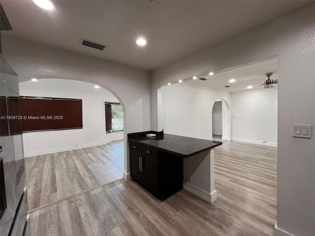 4888 NW 8th Ct, Plantation, FL 33317 - kitchen featuring arched walkways, open floor plan, light wood-style floors, a ceiling fan, and recessed lighting