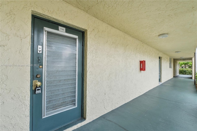 9091 Lime Bay Blvd Unit 110, Tamarac, FL 33321 - view of exterior entry featuring stucco siding and elevator