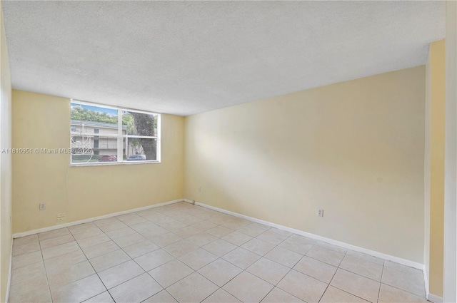 9091 Lime Bay Blvd Unit 110, Tamarac, FL 33321 - spare room featuring a textured ceiling, light tile patterned floors, and baseboards