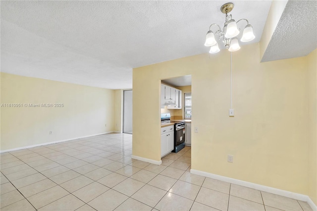 9091 Lime Bay Blvd Unit 110, Tamarac, FL 33321 - unfurnished room with a chandelier, a textured ceiling, light tile patterned flooring, and baseboards