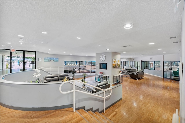 9091 Lime Bay Blvd Unit 110, Tamarac, FL 33321 - living area with a textured ceiling, wood finished floors, and recessed lighting