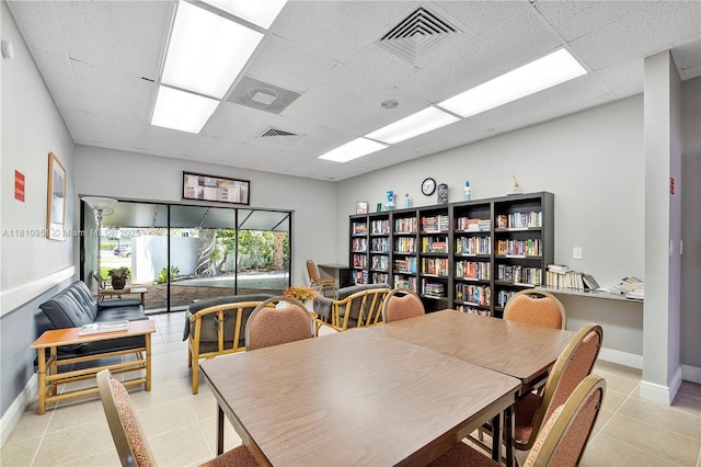 9091 Lime Bay Blvd Unit 110, Tamarac, FL 33321 - office area with a paneled ceiling, light tile patterned floors, and baseboards