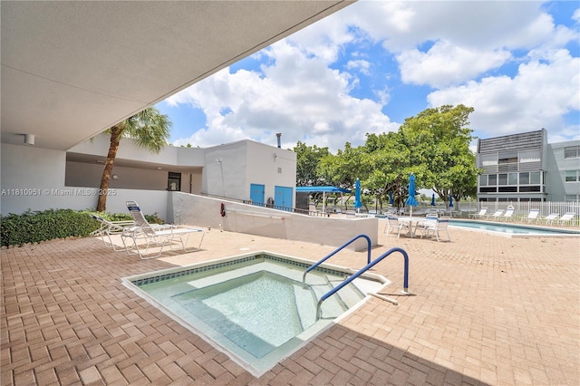 9091 Lime Bay Blvd Unit 110, Tamarac, FL 33321 - community pool featuring a community hot tub and a patio