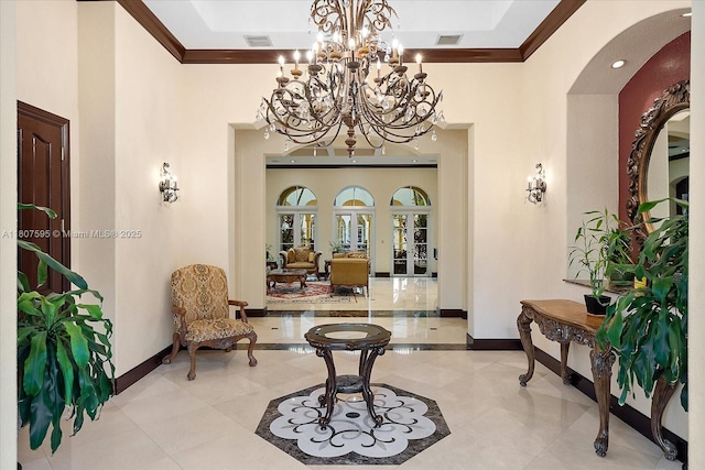 18451 SW 158th St, Miami, FL 33187 - entryway featuring ornamental molding, baseboards, arched walkways, light tile patterned flooring, and a chandelier