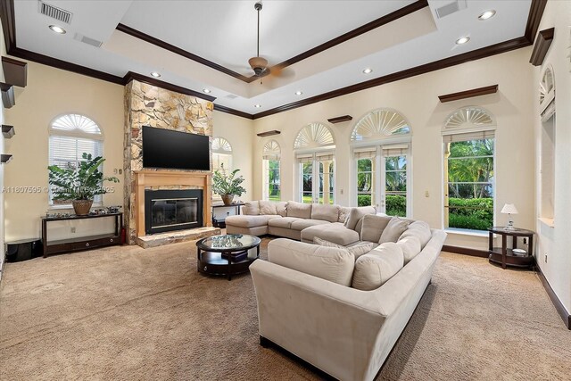 18451 SW 158th St, Miami, FL 33187 - living area featuring ornamental molding, carpet, recessed lighting, a stone fireplace, and a tray ceiling