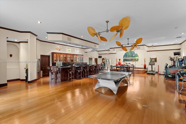18451 SW 158th St, Miami, FL 33187 - game room with ornamental molding, recessed lighting, light wood-type flooring, and a community bar