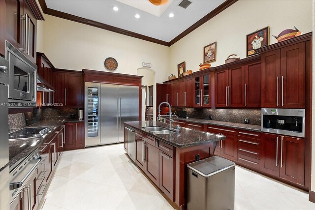 18451 SW 158th St, Miami, FL 33187 - kitchen featuring built in appliances, dark brown cabinets, a sink, crown molding, and tasteful backsplash