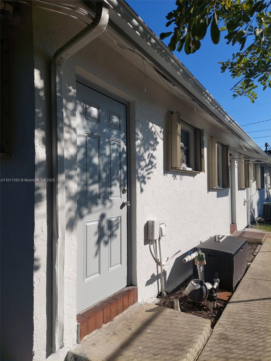2419-2421 Johnson St, Hollywood, FL 33020 - property entrance with stucco siding and central air condition unit