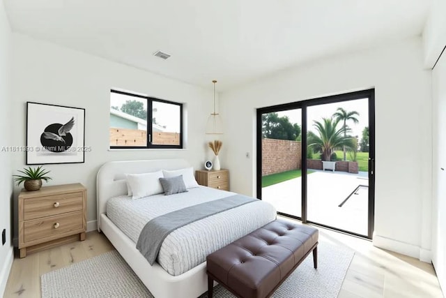 5700 SW 56th St, Davie, FL 33314 - bedroom with access to exterior, light wood finished floors, and multiple windows