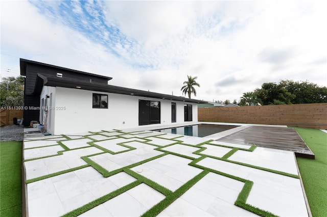 5700 SW 56th St, Davie, FL 33314 - back of property featuring a fenced backyard, a patio area, and stucco siding
