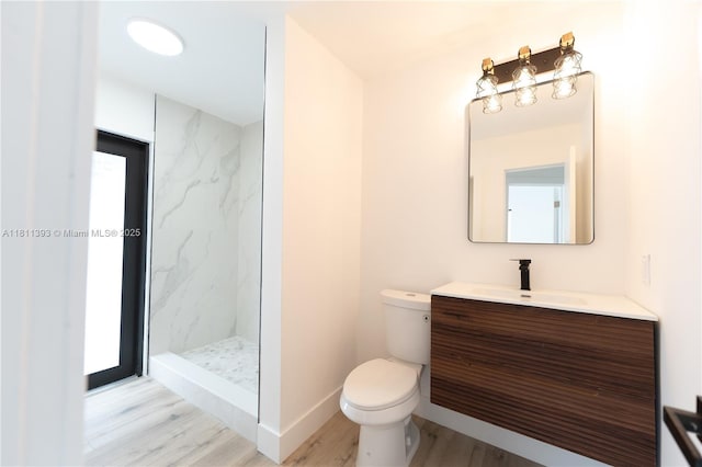 5700 SW 56th St, Davie, FL 33314 - bathroom with vanity, a marble finish shower, wood finished floors, toilet, and baseboards