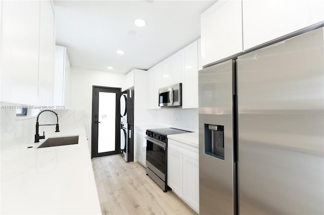 5700 SW 56th St, Davie, FL 33314 - kitchen featuring stainless steel appliances, a sink, light wood finished floors, white cabinetry, and recessed lighting