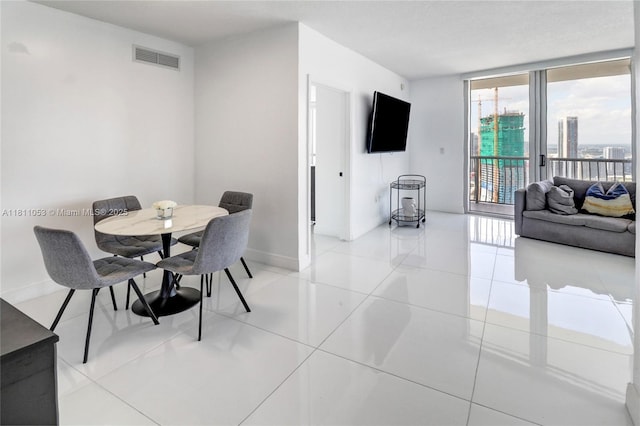 1750 N Bayshore Dr Unit 5214, Miami, FL 33132 - dining space featuring baseboards, light tile patterned floors, and floor to ceiling windows