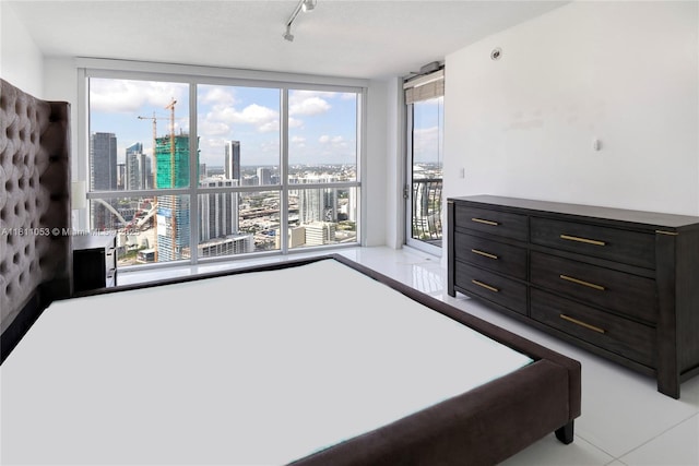 1750 N Bayshore Dr Unit 5214, Miami, FL 33132 - tiled bedroom featuring a view of skyline, access to exterior, and track lighting