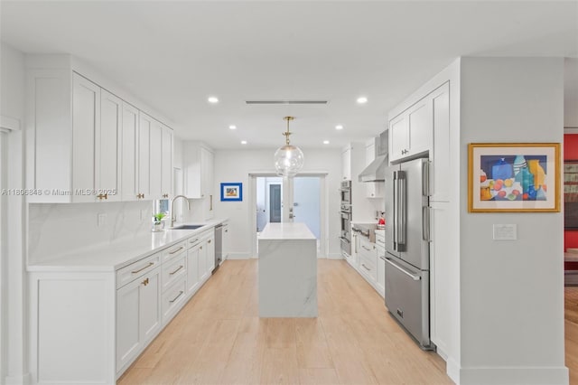 14270 SW 74th Ct, Palmetto Bay, FL 33158 - kitchen featuring stainless steel appliances, exhaust hood, a kitchen island, recessed lighting, and light wood finished floors