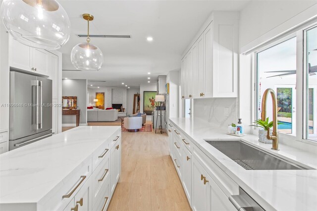 14270 SW 74th Ct, Palmetto Bay, FL 33158 - kitchen featuring stainless steel appliances, light wood finished floors, white cabinets, recessed lighting, and light stone counters