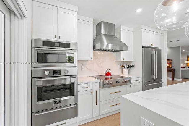 14270 SW 74th Ct, Palmetto Bay, FL 33158 - kitchen featuring stainless steel appliances, wall chimney range hood, a warming drawer, white cabinets, and light stone counters