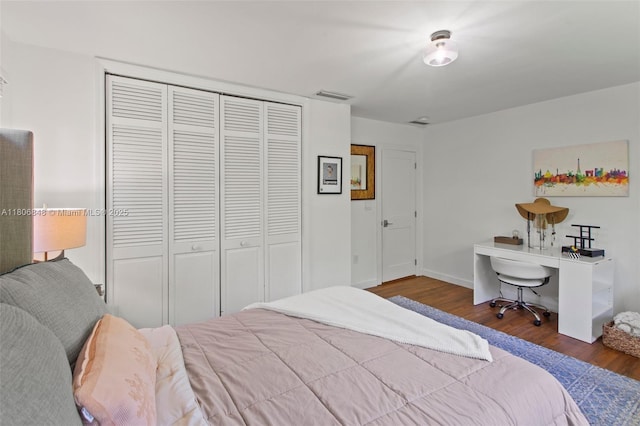 14270 SW 74th Ct, Palmetto Bay, FL 33158 - bedroom featuring wood finished floors, a closet, and baseboards